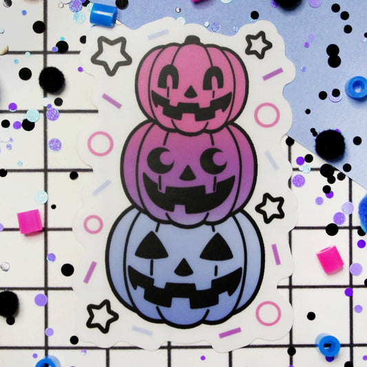 Three kawaii pastel halloween pumpkins stacked on each other.