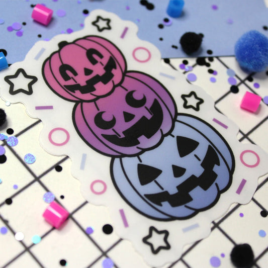 Cute pastel halloween jack-o-lanterns stacked on top of each other.