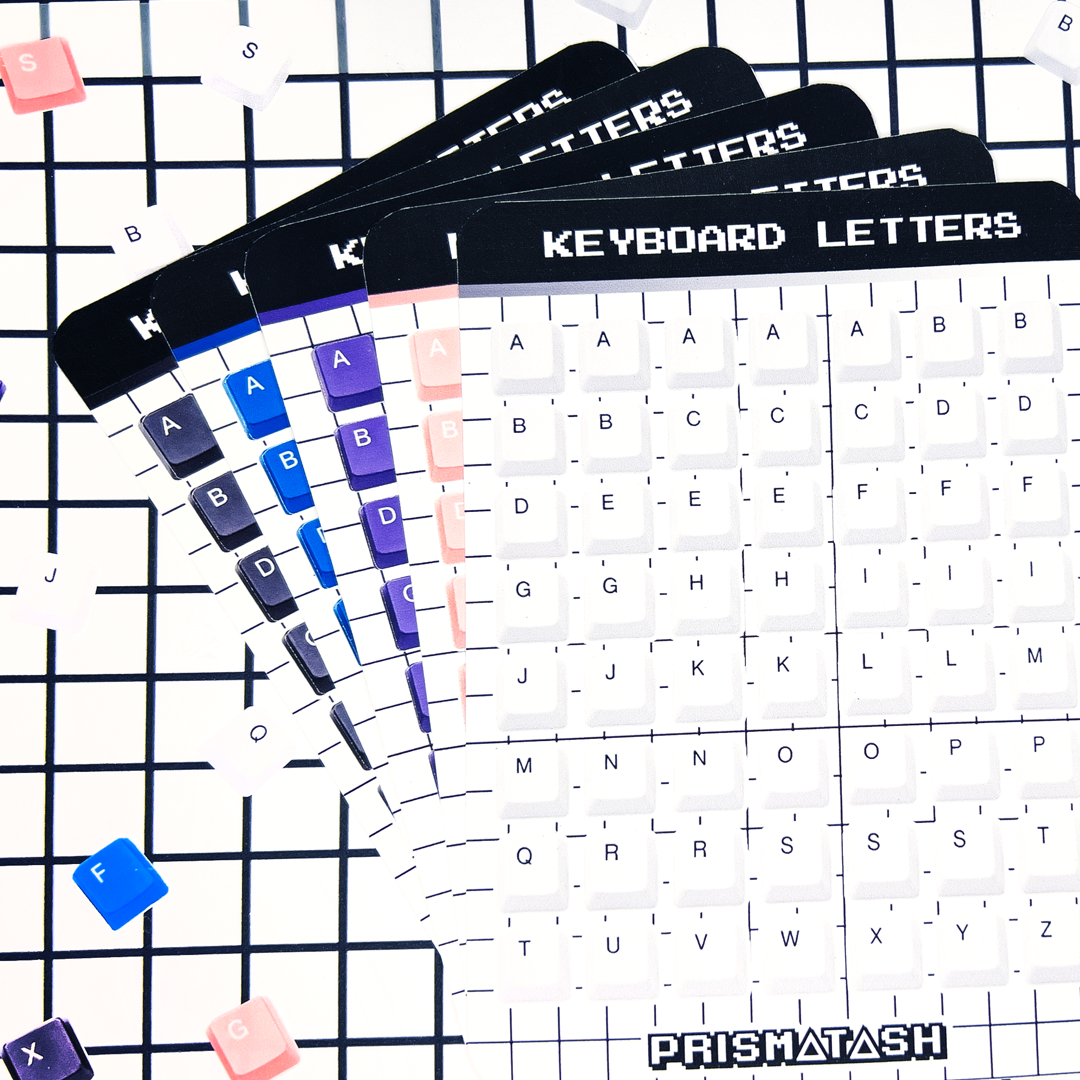A fanned-out keyboard letters sticker sheets showing different colored key labels and the brand name PRISMATASH at the bottom, set against a black grid background with scattered keycap stickers.