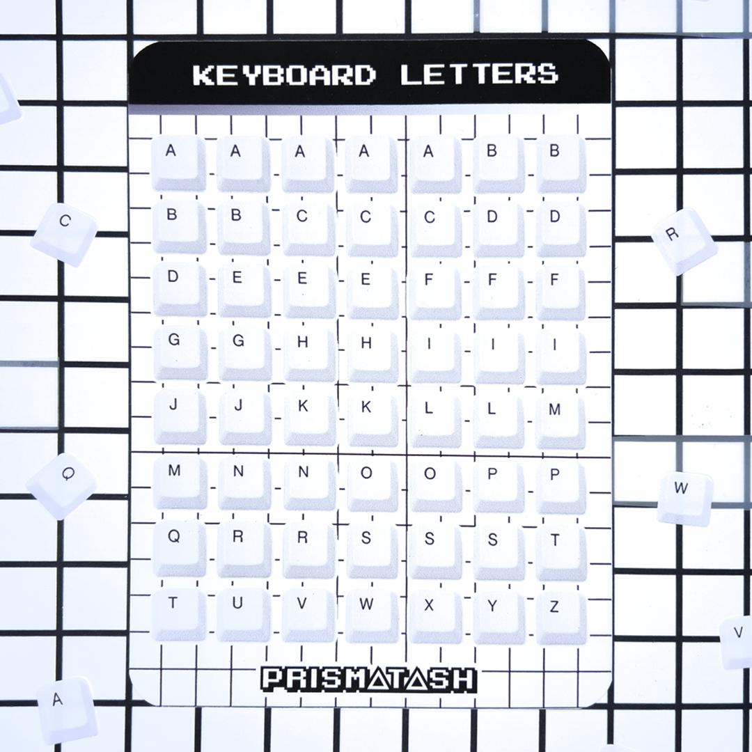 A square white board labeled 'KEYBOARD LETTERS' with a grid of letter keys and the brand name 'PRISMATASH' at the bottom, shown on a black grid background with a few loose keycap stickers scattered around.