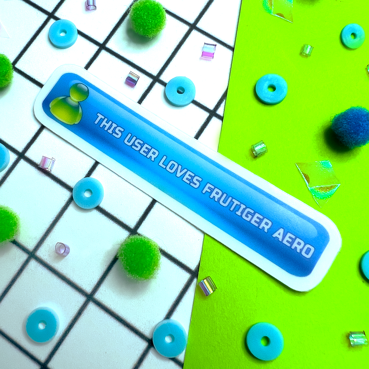 Blue sticker with text 'This user loves Frutiger Aero' on a colorful background