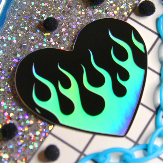 cute small holographic flame sticker with a black background