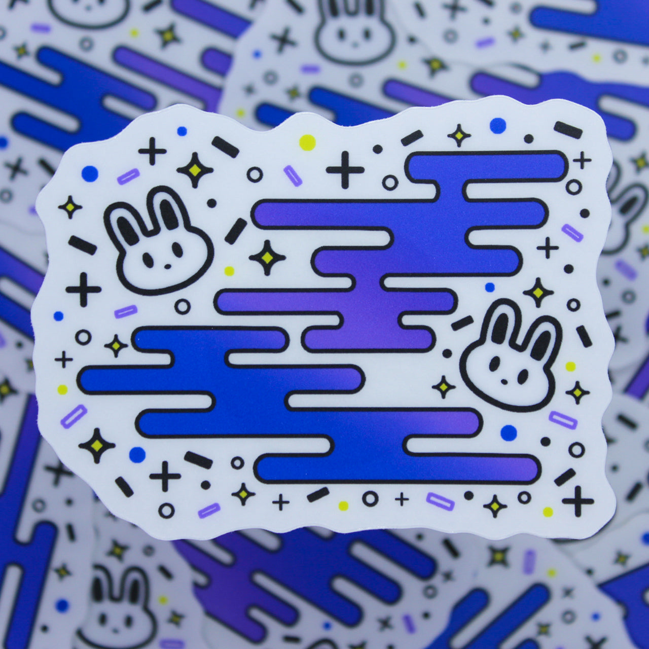 Sticker of two bunnies surrounded by fun shapes. Frosted matte diecut sticker