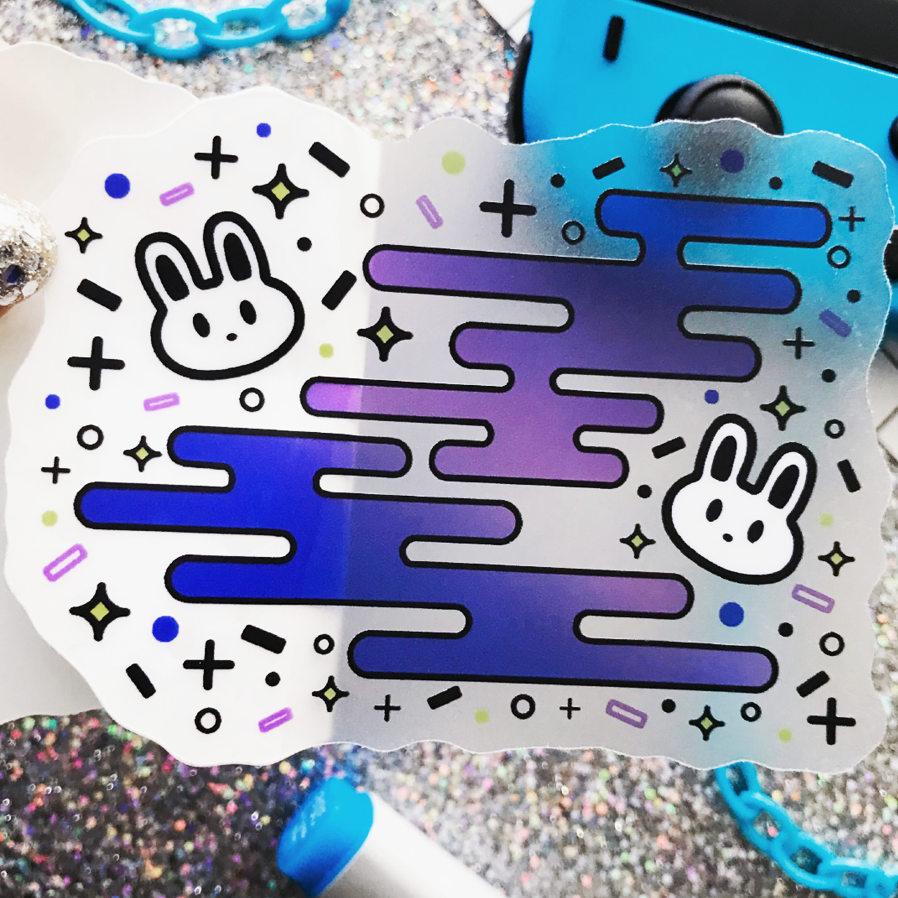 Two kawaii bunnies surrounded by fun shapes, printed on transparent matte vinyl